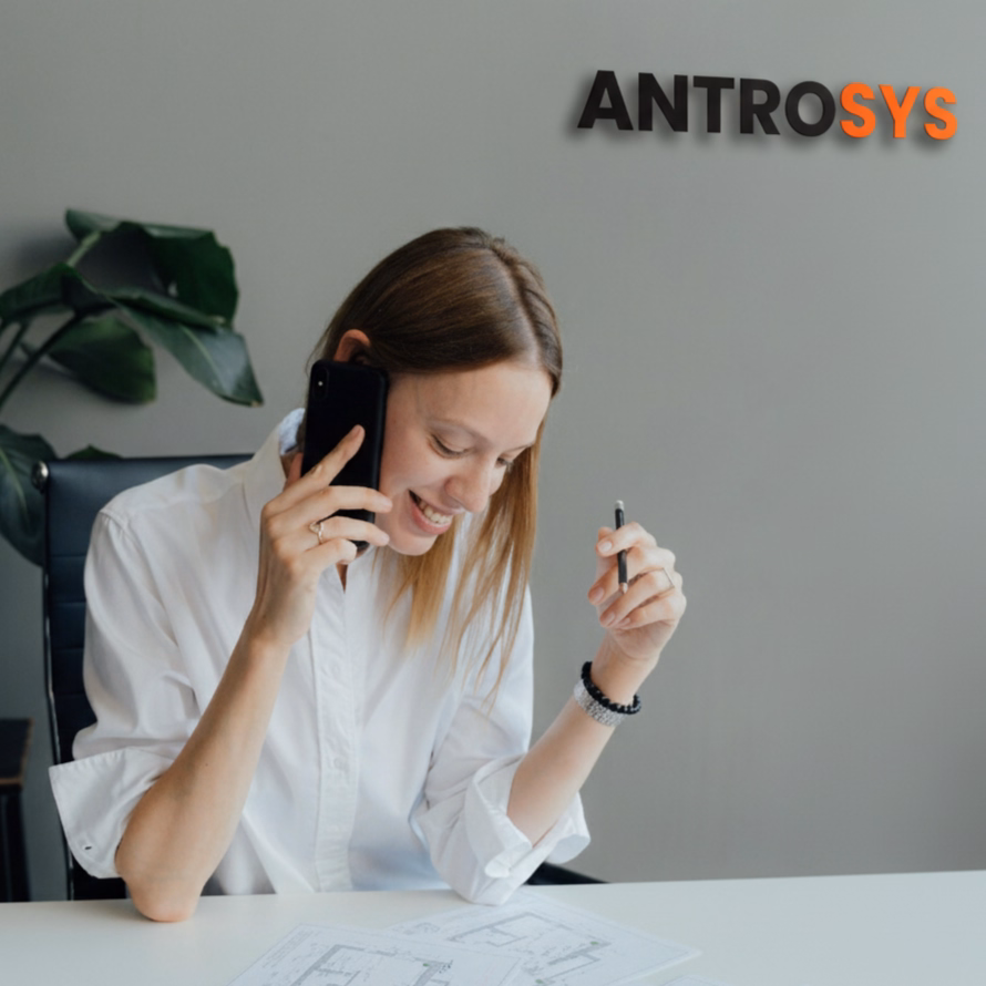 A member of the AntroSys team on a phone call at her desk